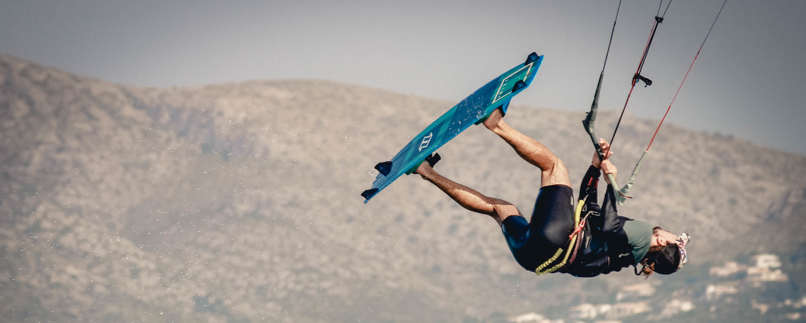 Kitesurfer jumping backwards over the water