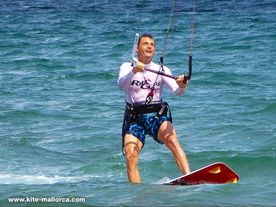A man riding a kiteboard on the Mediterranean sea