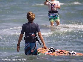 A teacher bringing a kiteboard to his student