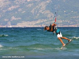 Daniel unhooked into blind. An intermediate kitesurf jump A man jumping an unhooked turn with a kiteboard over the water .