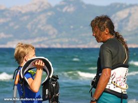 A child talking with a man in front of the sea