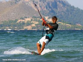Daniel kitesurfing on his kiteboard over the waves