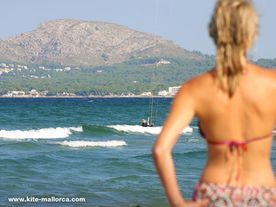 A woman looking to his son how is training well independent the kitesurfing lessons