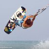 Thumb Picture: A man flying through the air while riding a kiteboard.