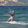 Thumb Picture: A child looking to his kite while riding on his kiteboard